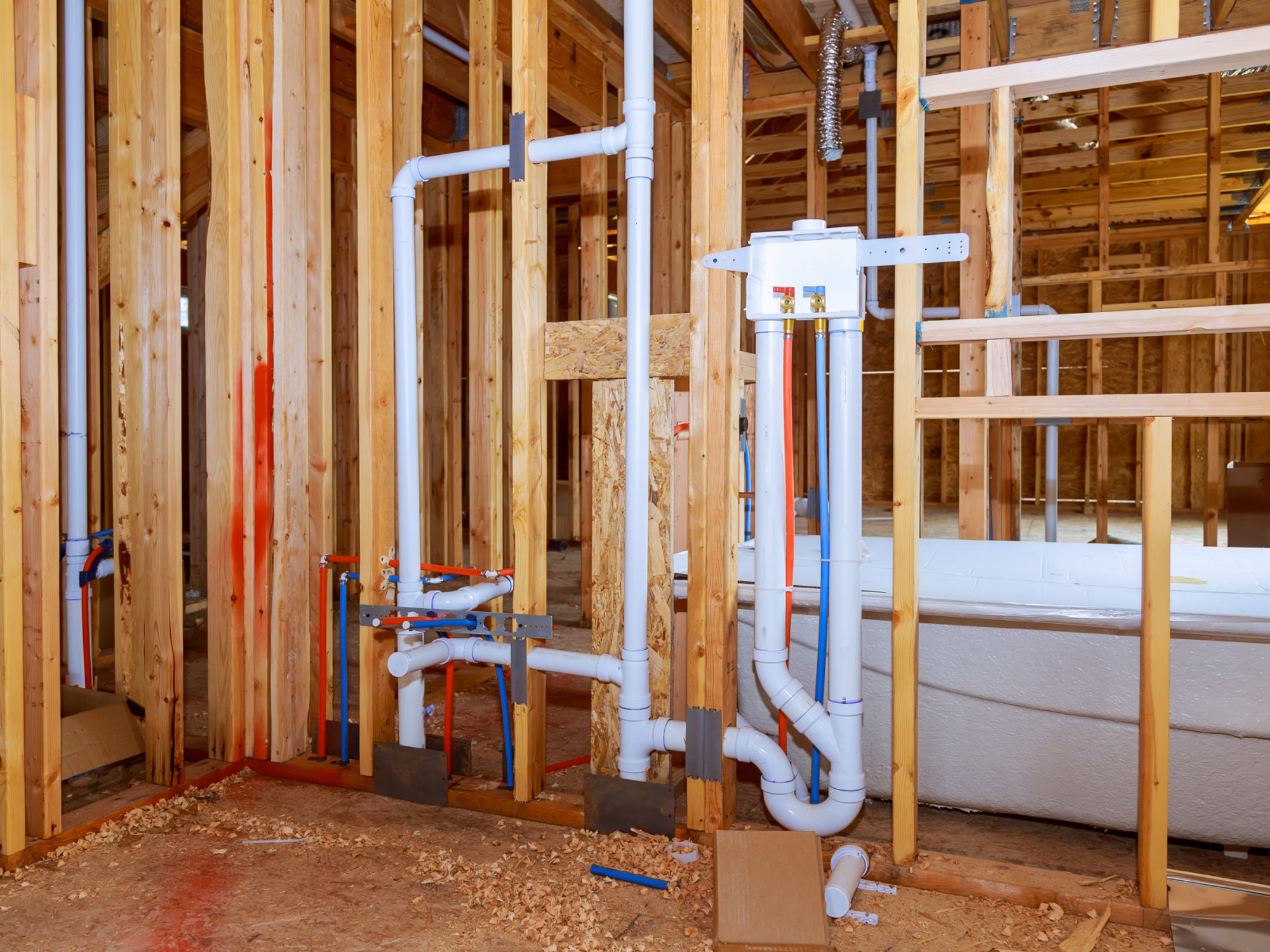 Basement bathroom plumbing rough-in with drain and water supply pipes installed