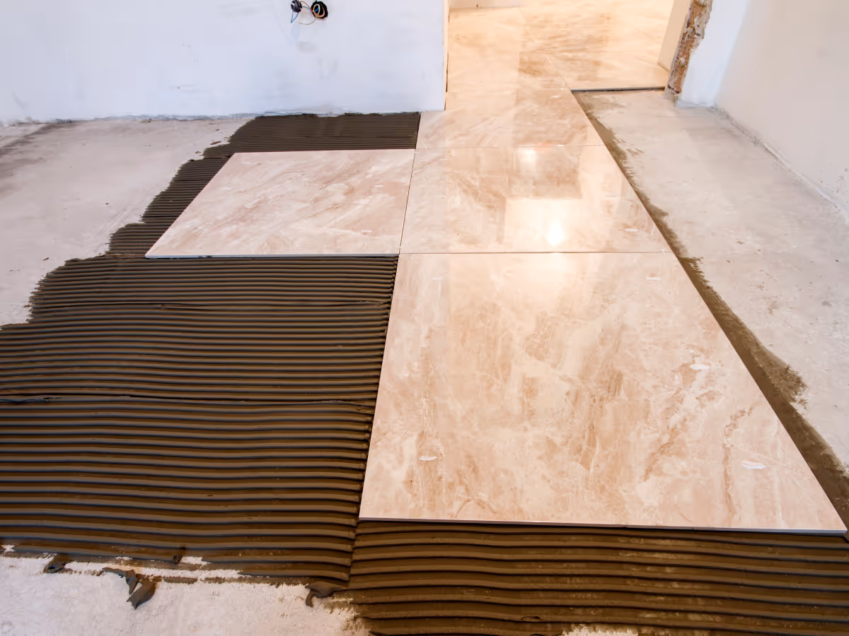 Basement ceramic tile flooring installation during renovation