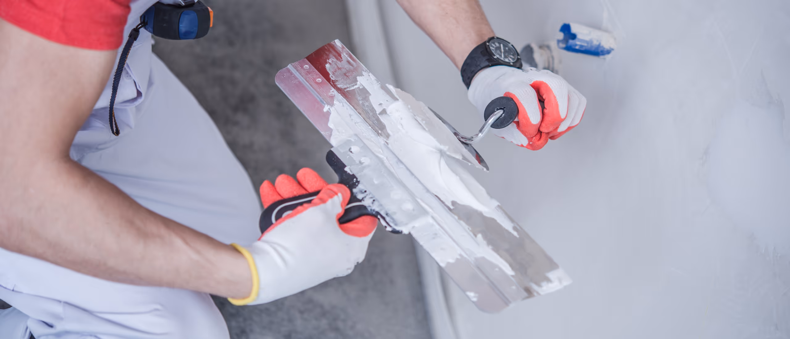 Basement drywall patching with joint compound applied to repair damaged wall