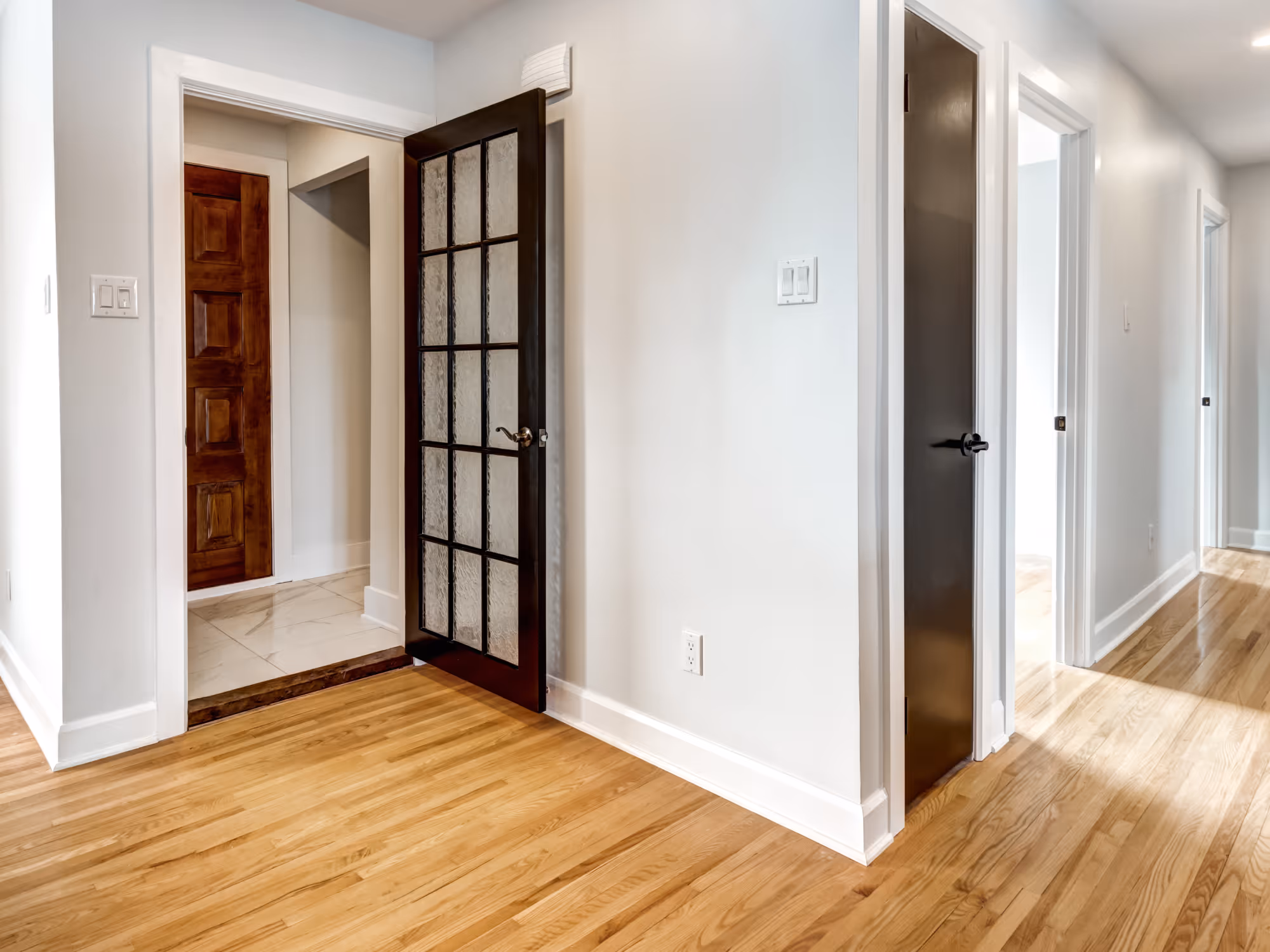 Basement hallway with installed laminate wood flooring