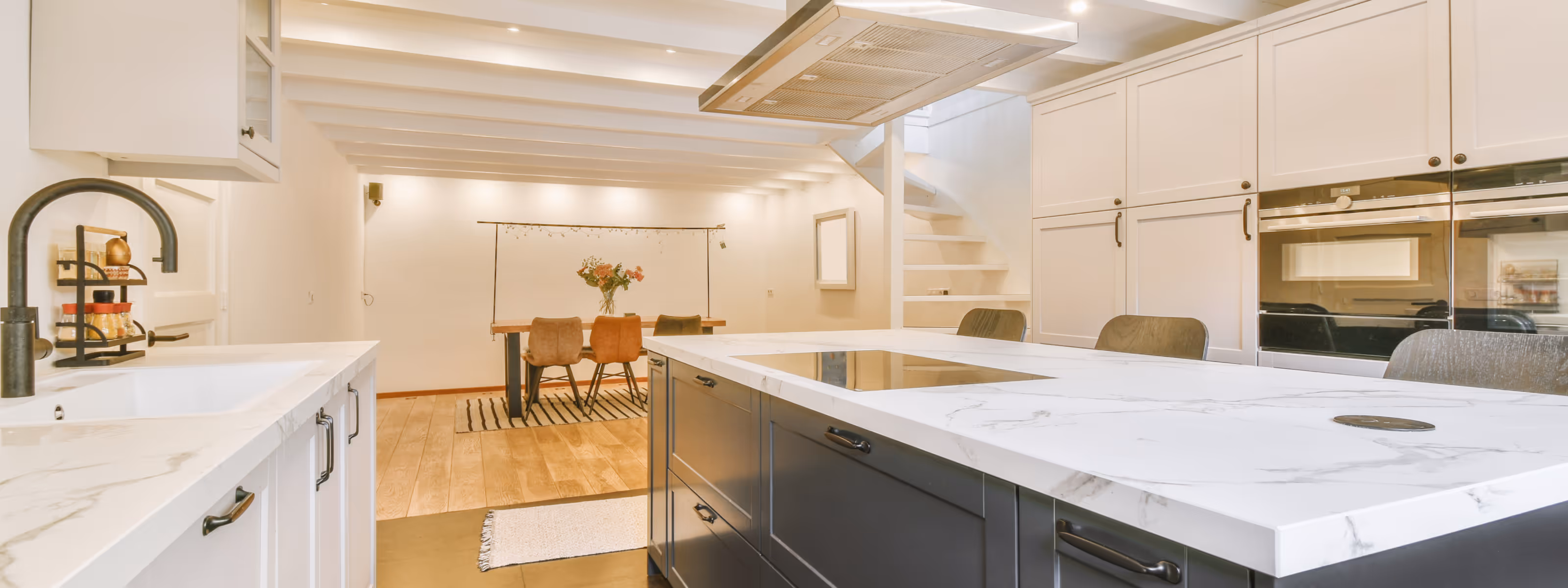 Modern basement kitchen renovation with island and quartz countertops. Open concept basement kitchen remodel with dining space