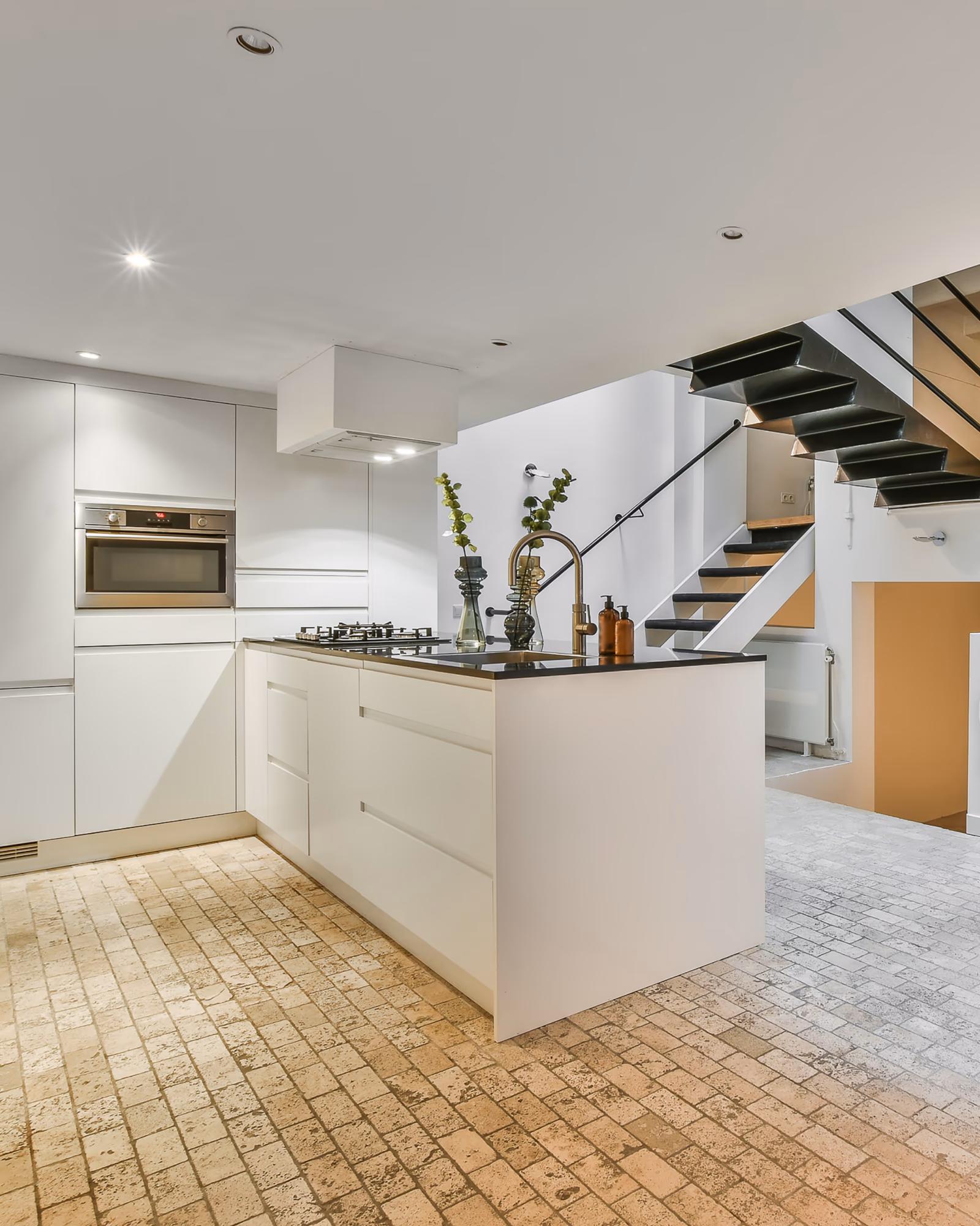 Modern basement kitchen renovation with island cooktop and custom cabinetry