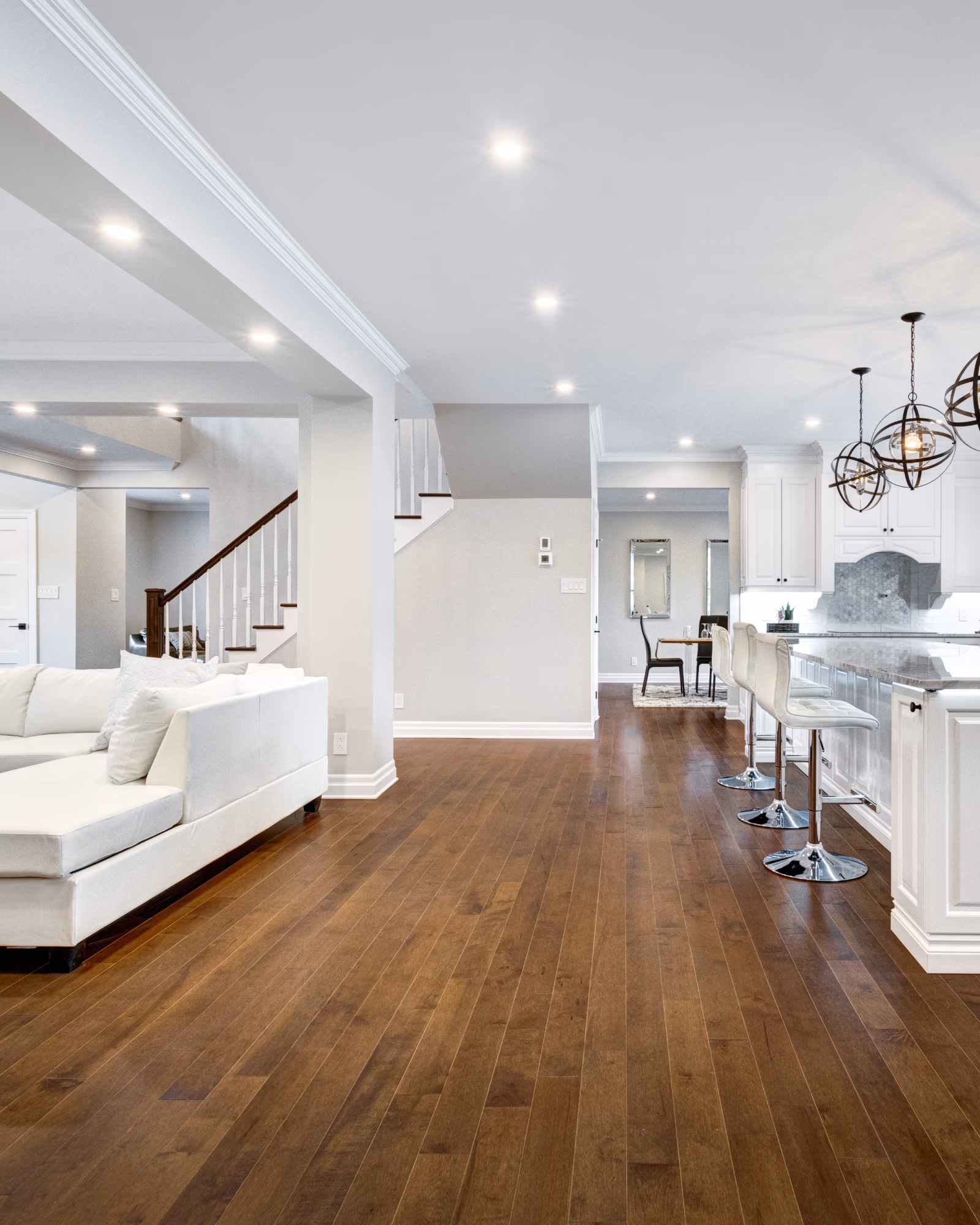 Finished basement renovation with modern flooring and staircase