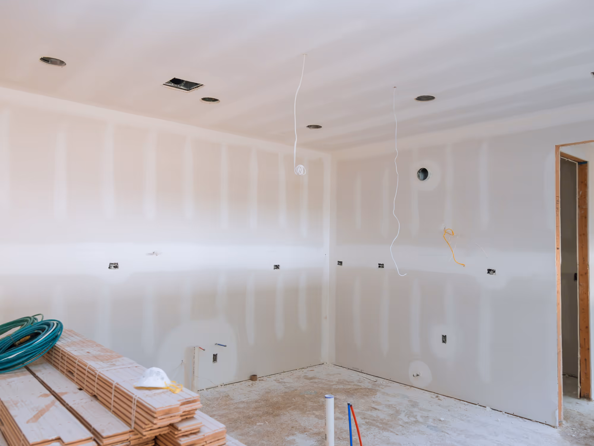 Basement drywall installation with ceiling drywall and recessed lighting