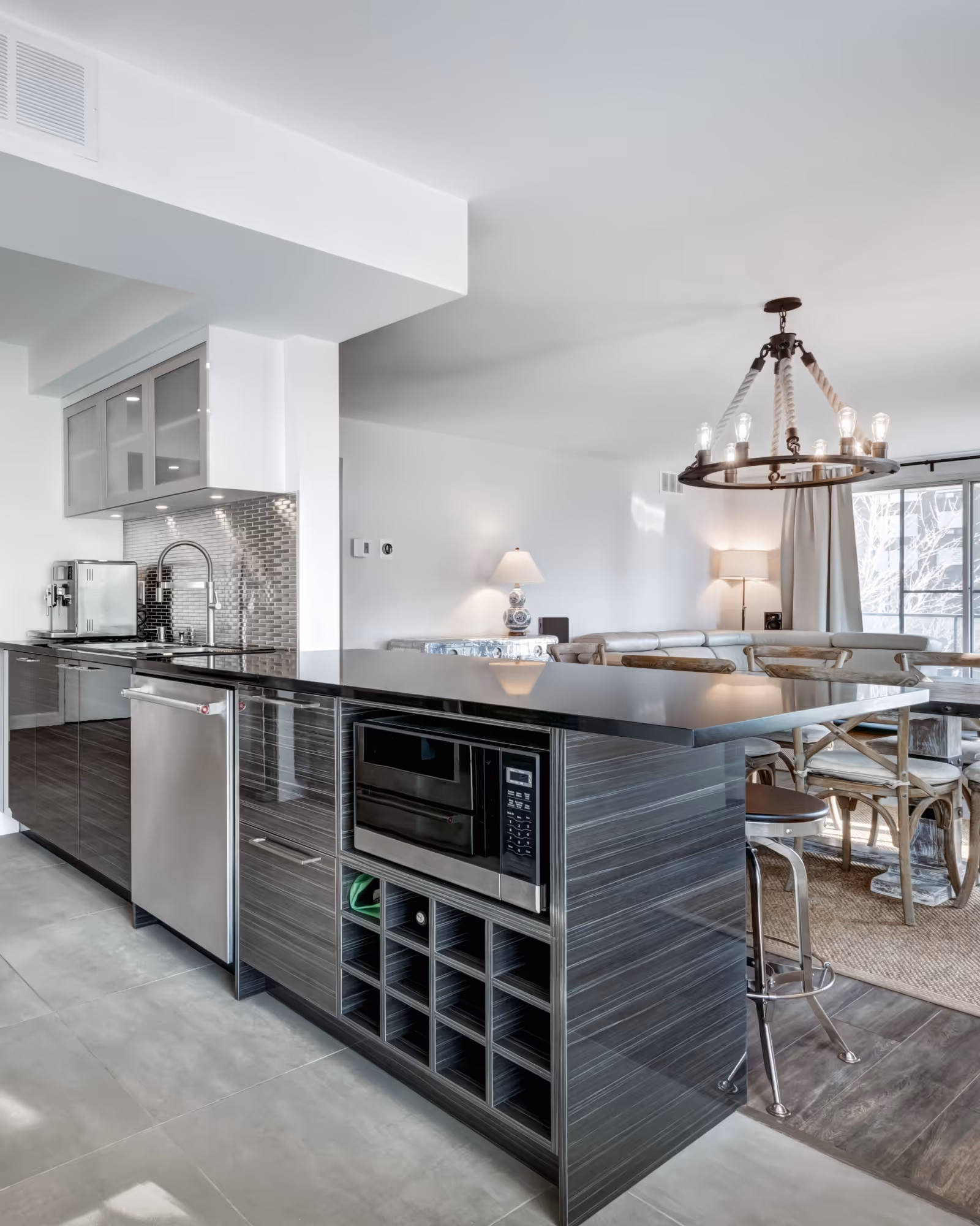 Finished kitchen remodel with oversized island, shaker cabinets, and pendant lighting