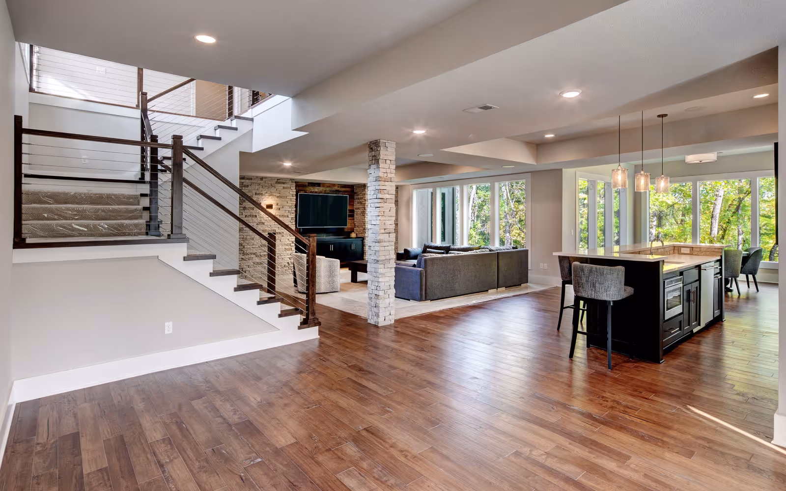 Finished basement with dark hardwood flooring and open-concept living area