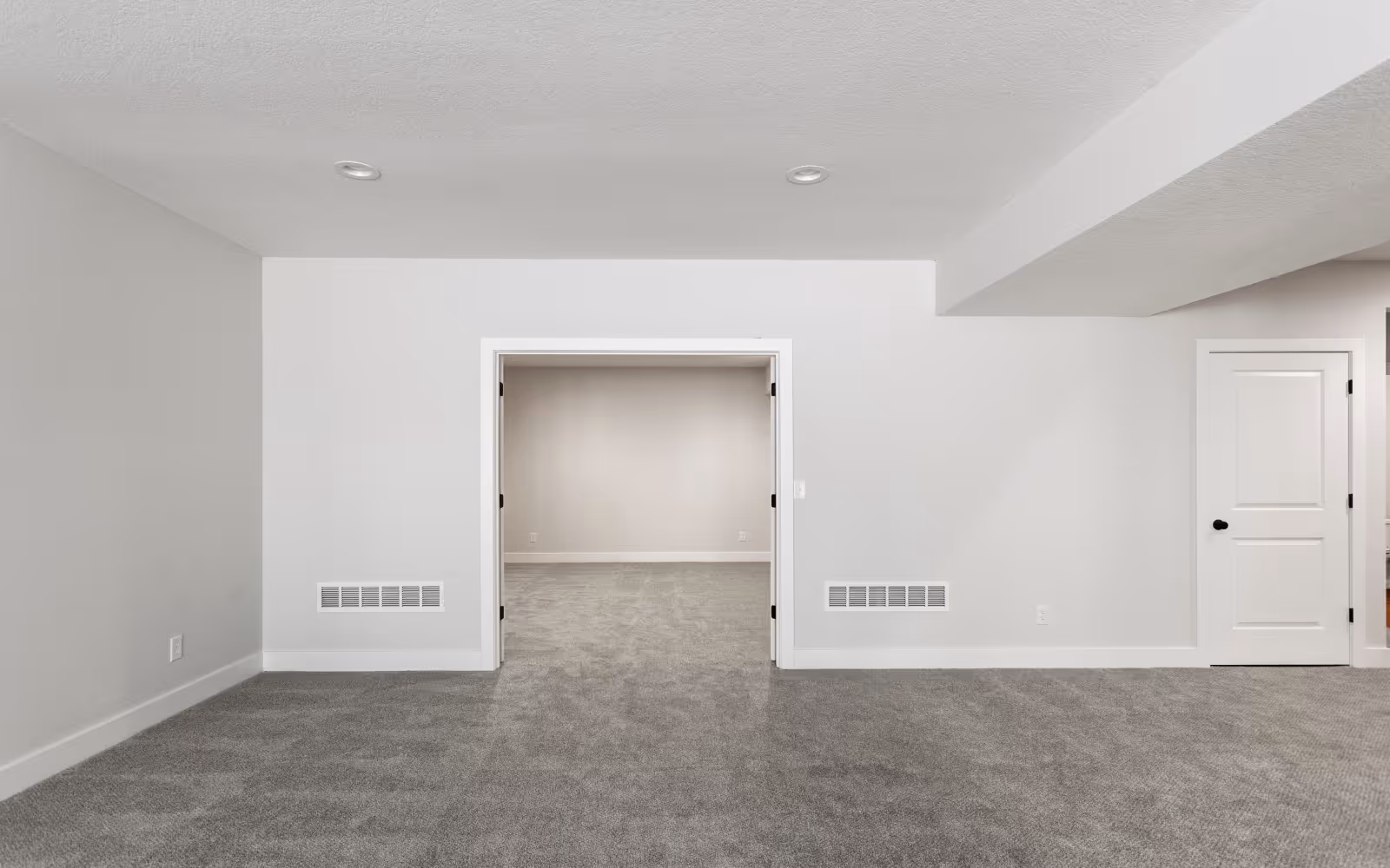 Basement family room with new grey wall-to-wall carpet installation