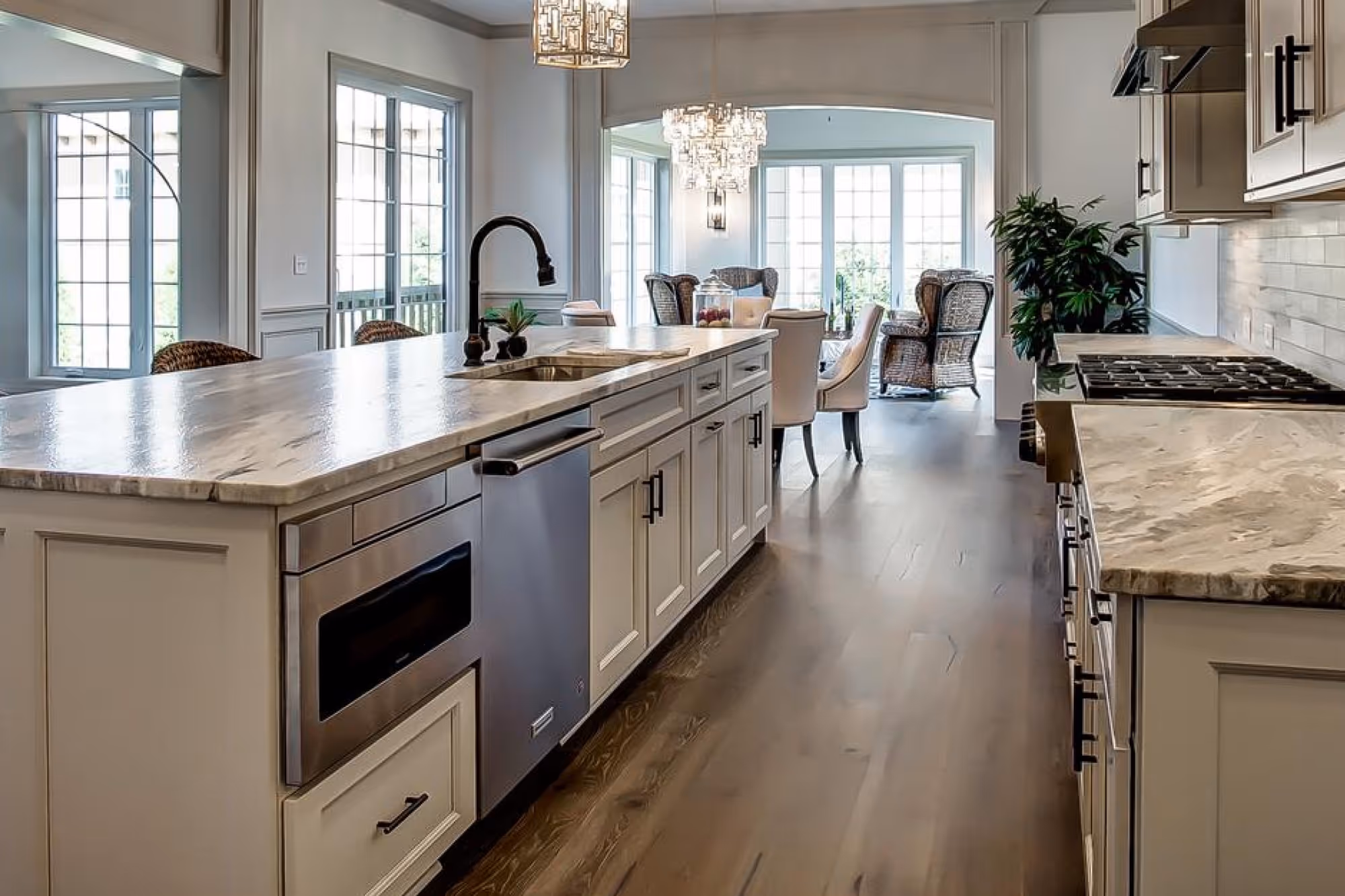 Kitchen renovation upgrades with stone counters, island seating, and stainless appliances
