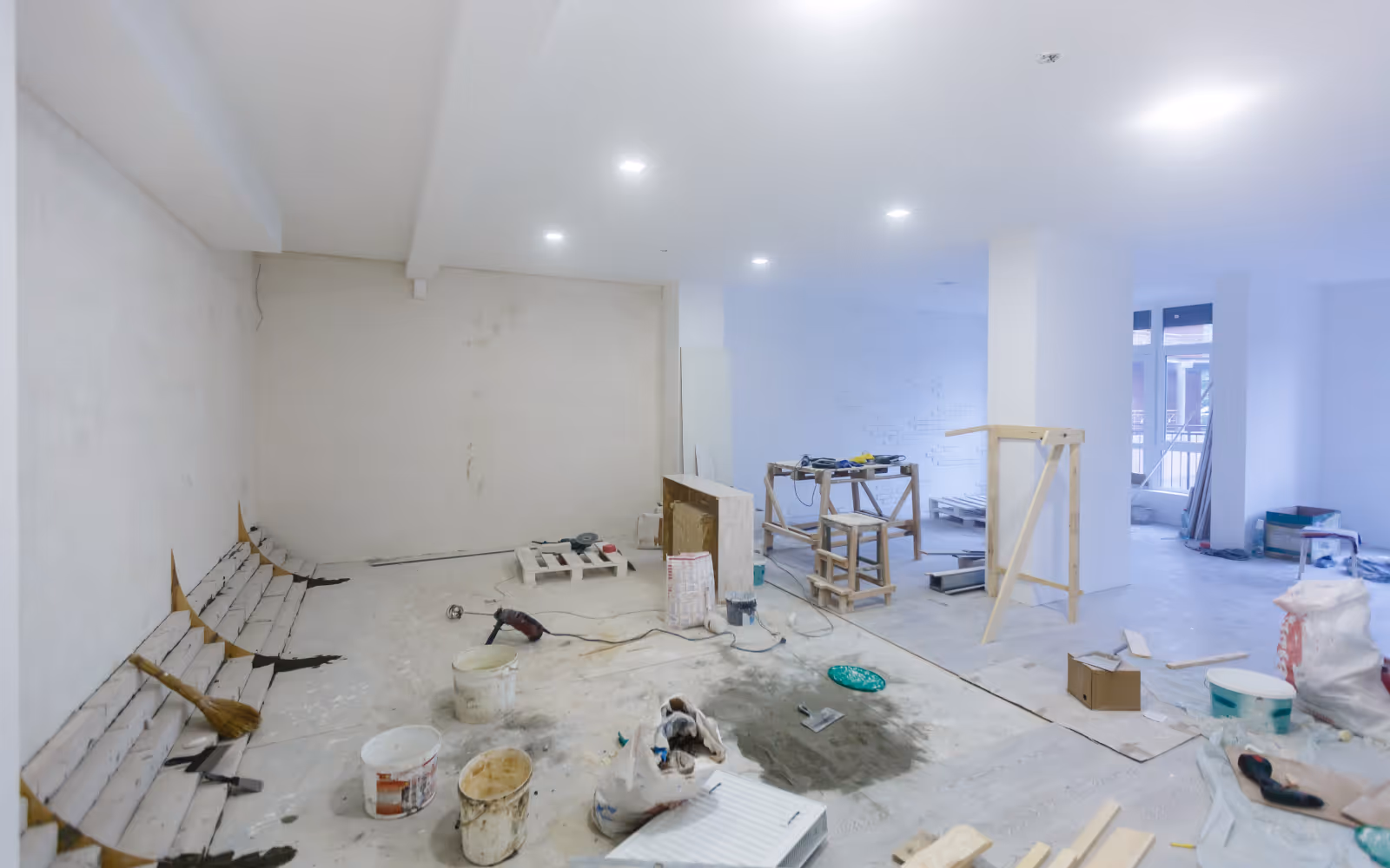 Basement drywall renovation in progress with walls and ceiling installed