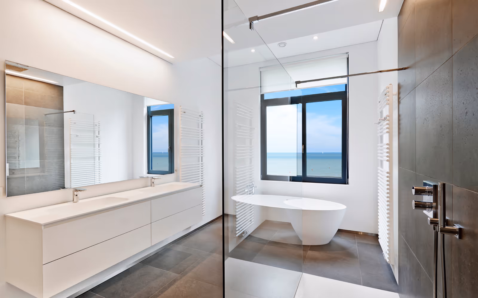 Modern bathroom renovation with double vanity, glass shower enclosure, and freestanding tub
