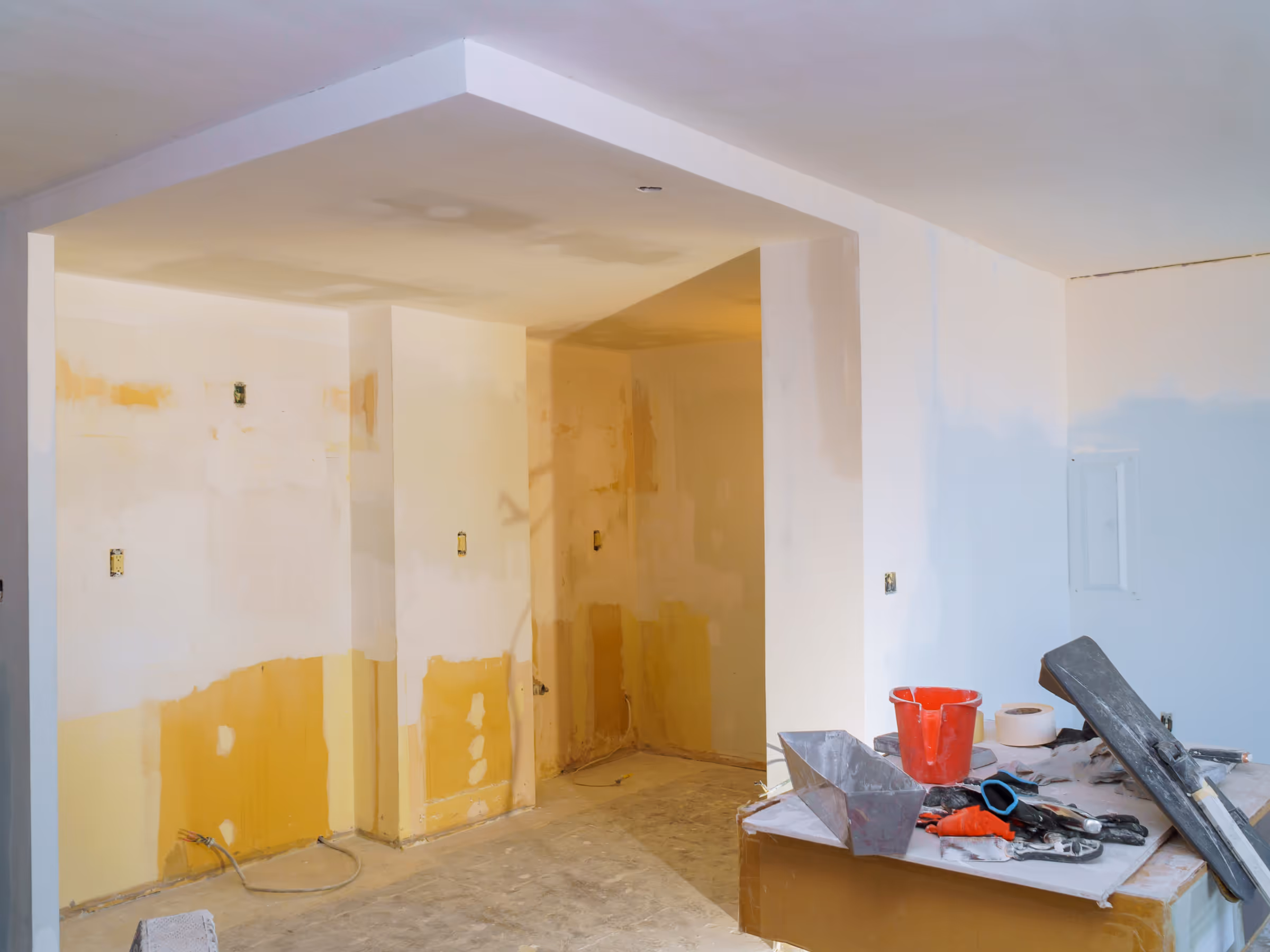 Basement drywall installation with electrical rough-in during basement renovation
