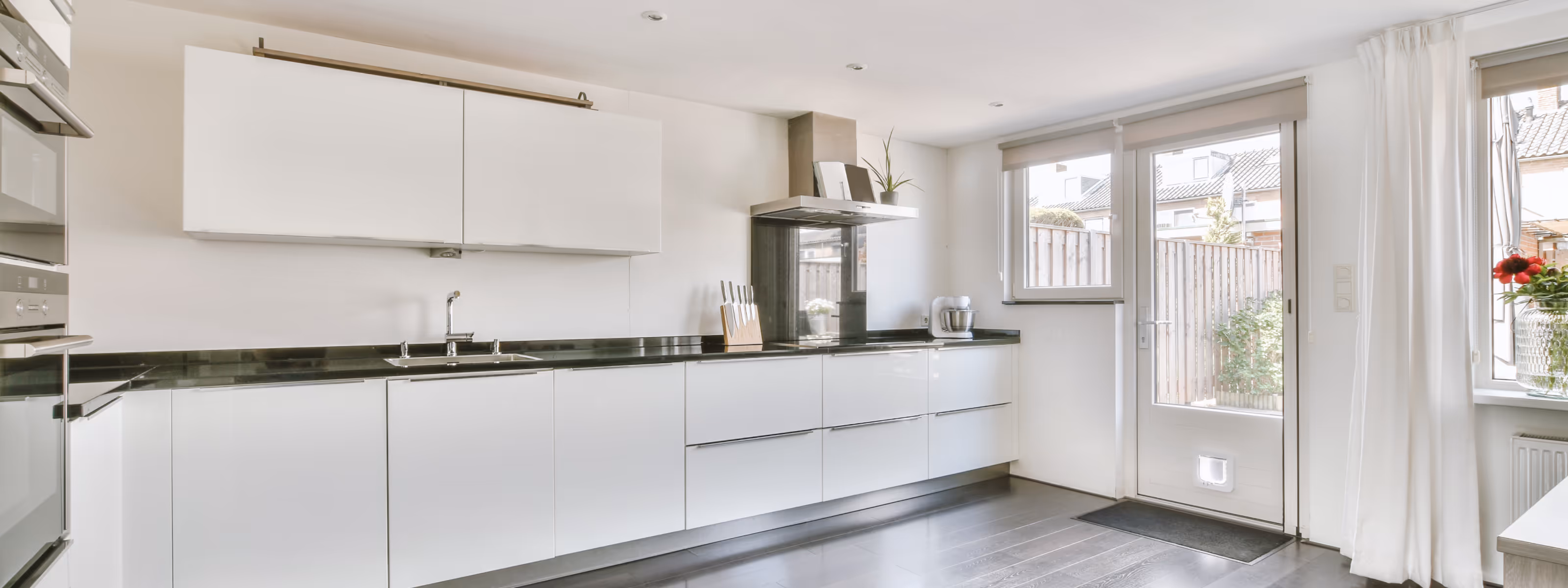 Freshly painted basement kitchen with white walls and modern cabinetry