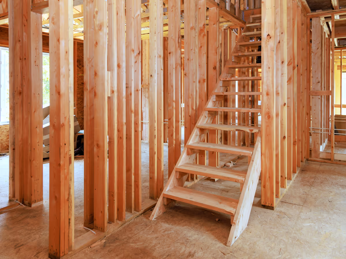 Structural wood framing for basement renovation including staircase framing