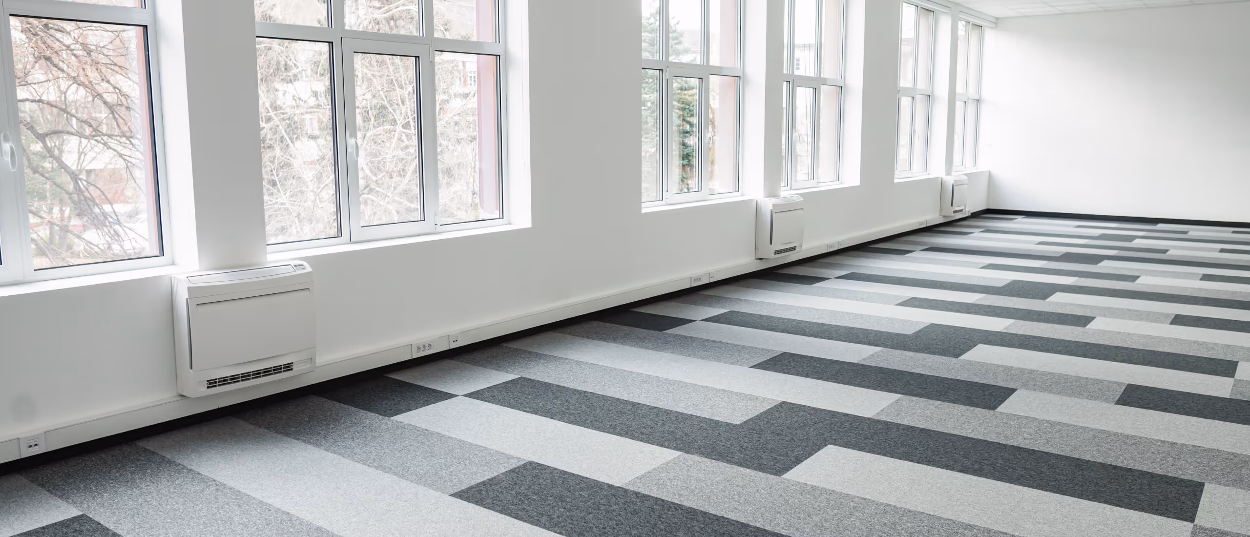 Modern carpet flooring installed in finished basement space