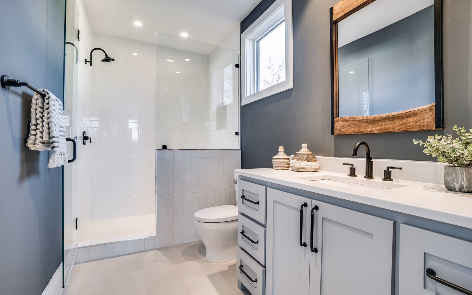 Custom shower installation with frameless glass and matte black fixtures
