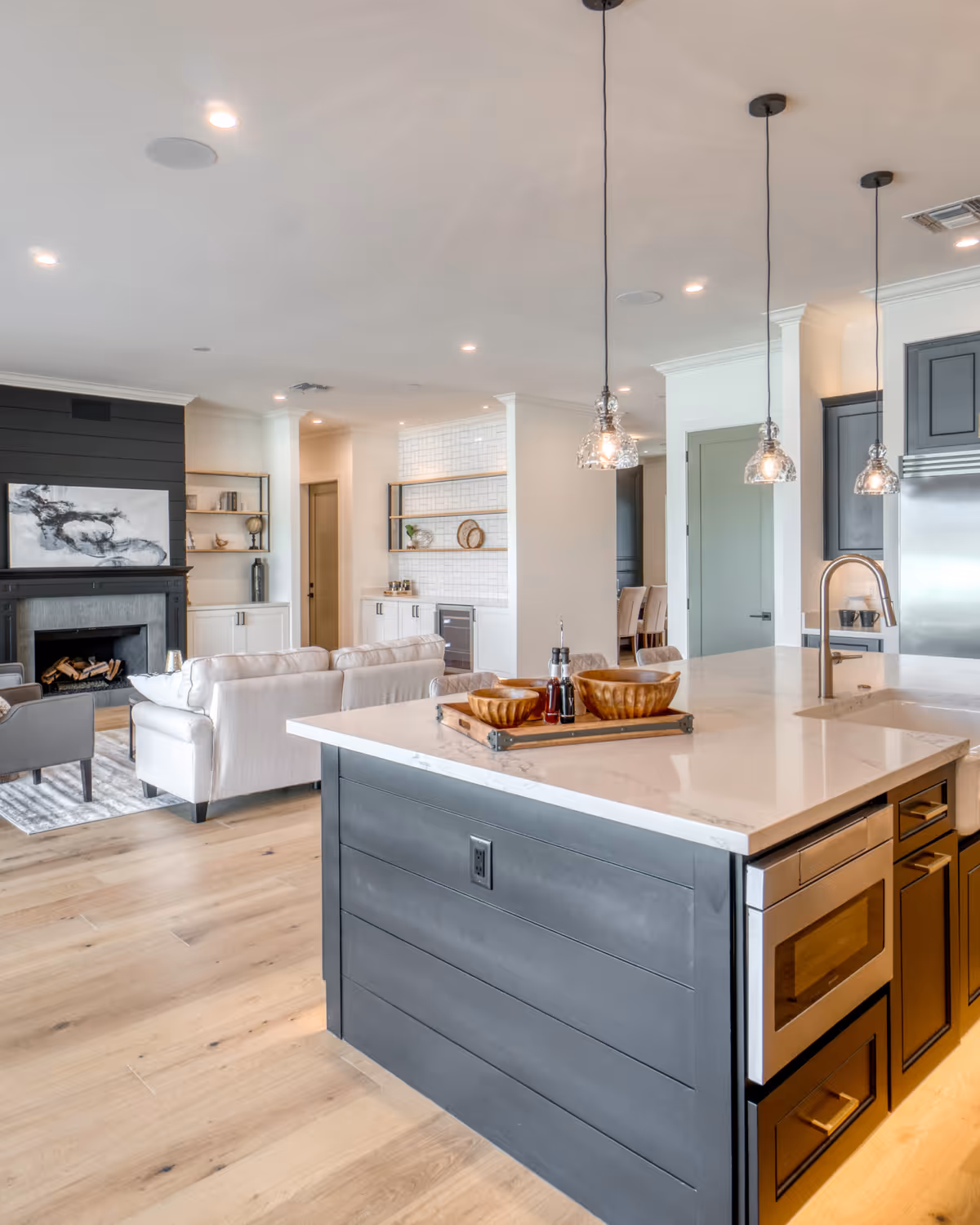 Bright white kitchen remodel with oversized island and pendant lighting in Durham Region, Ontario