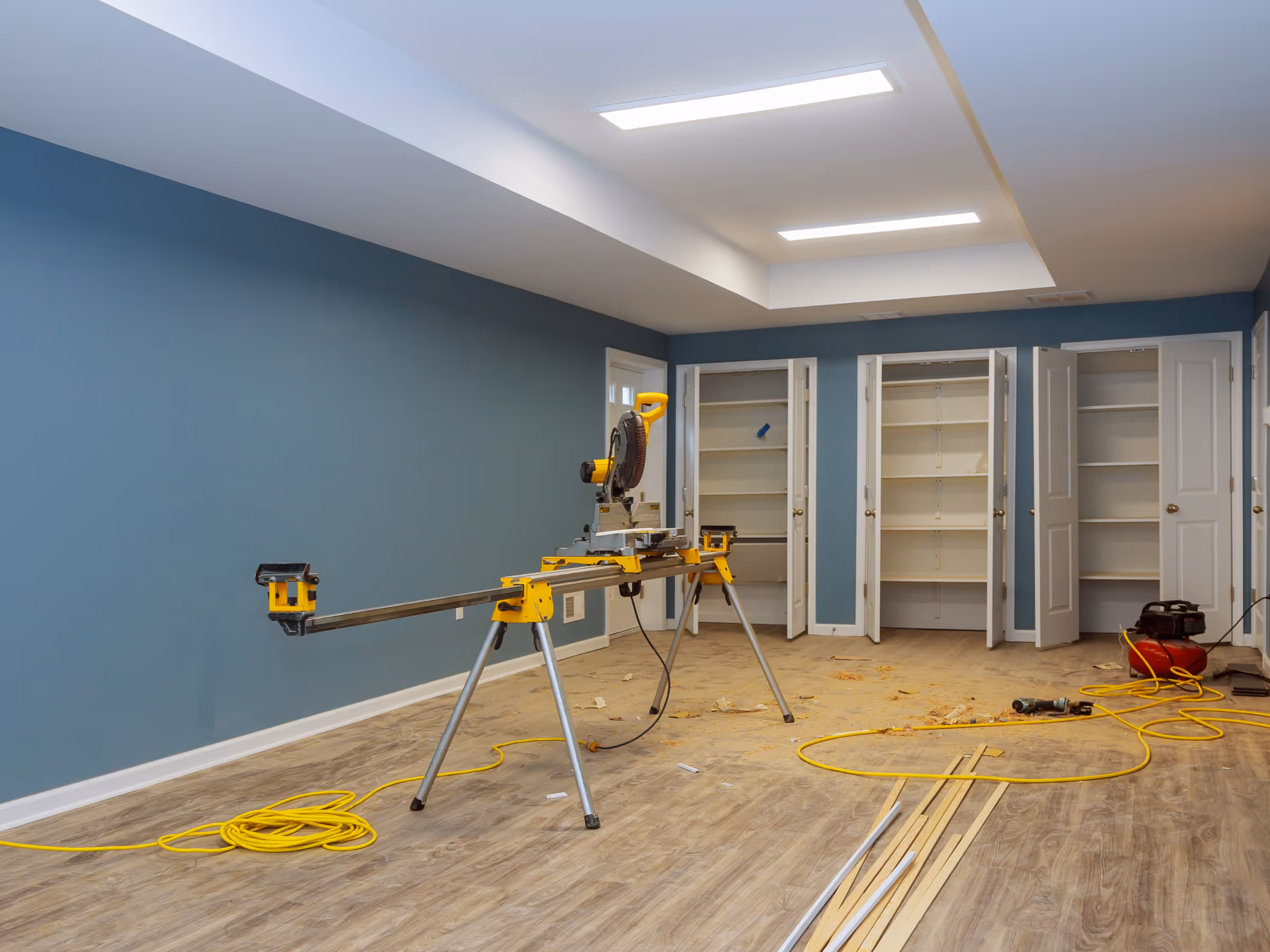 Basement painting project with freshly painted blue walls during renovation