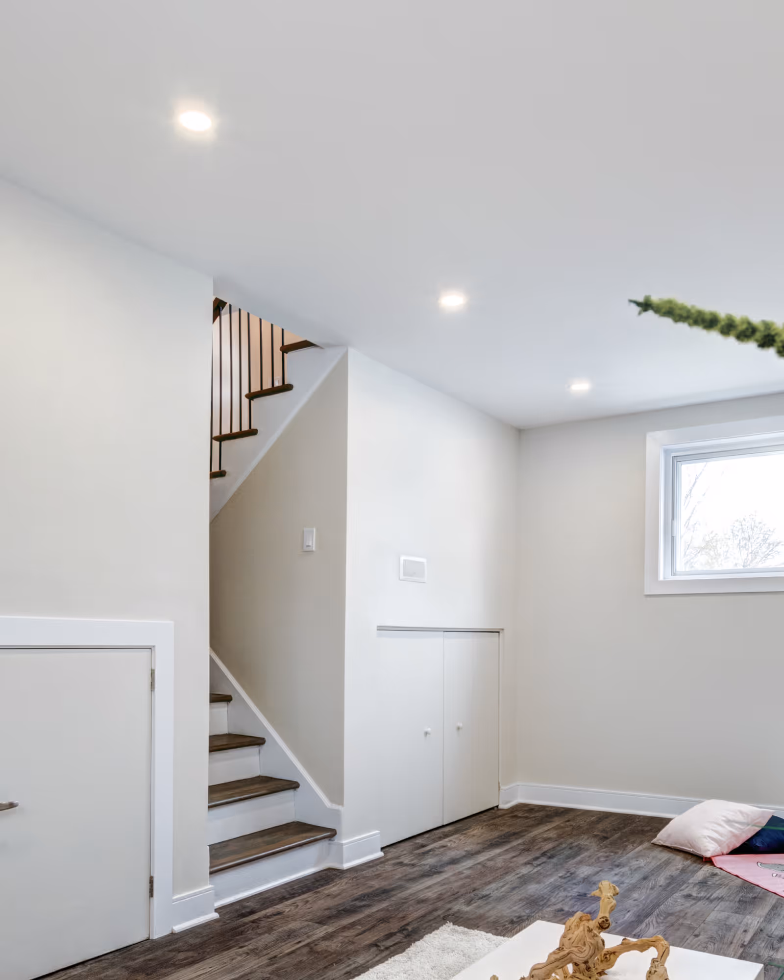 Finished basement remodel with staircase, recessed lighting, and luxury vinyl plank flooring