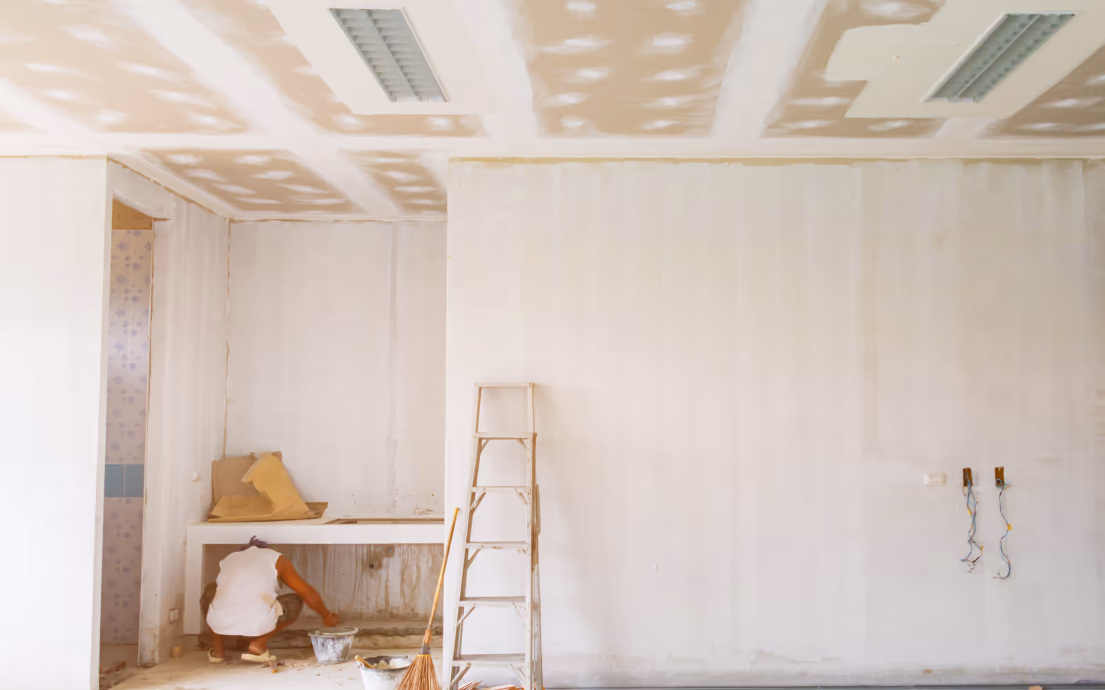 Drywall repair and finishing work before painting