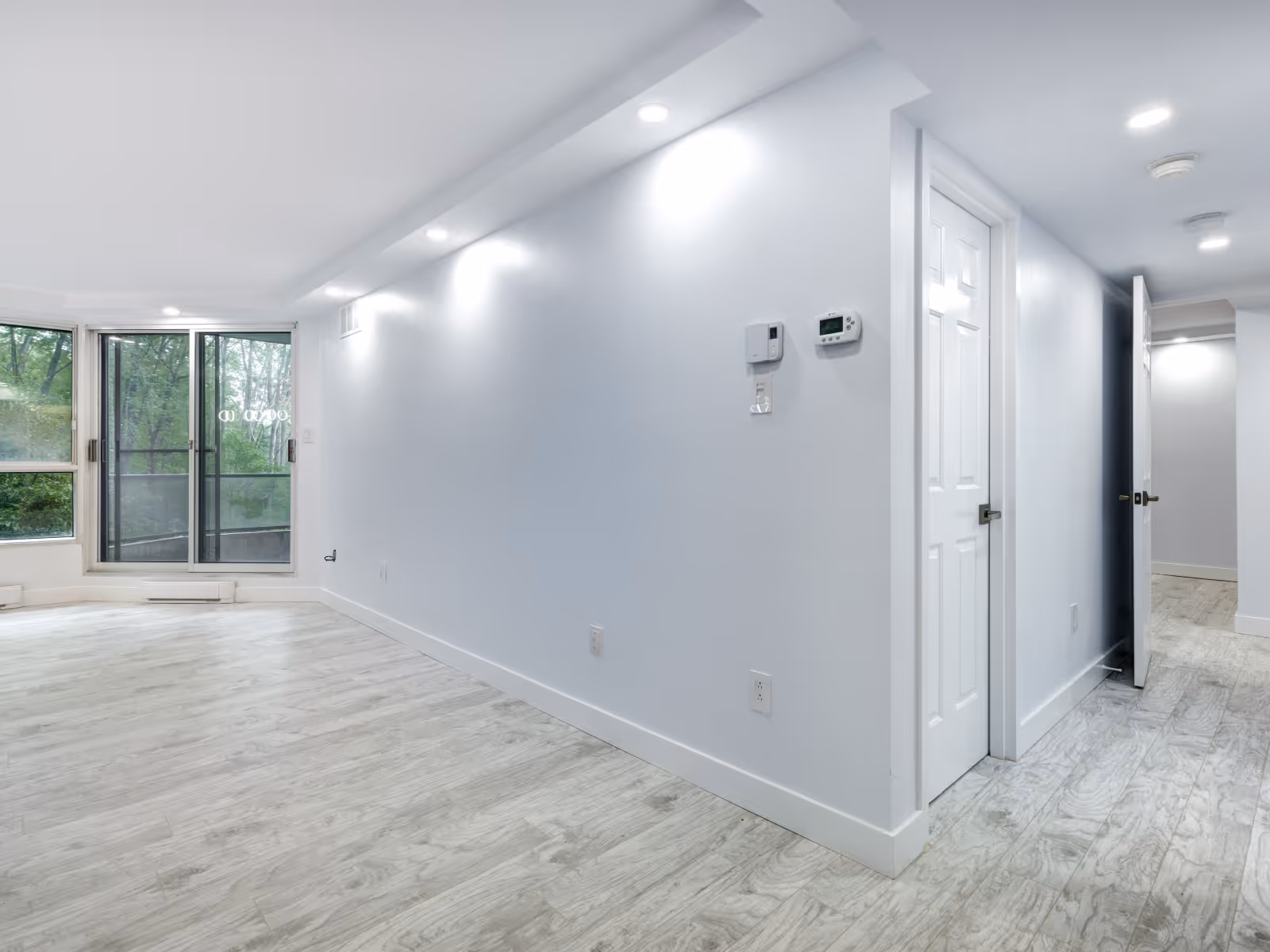 Freshly painted basement interior with new flooring and recessed lighting in Durham Region